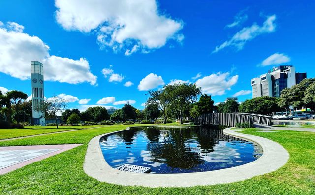 The clock tower, pond and gardens of The Square in central Palmerston North.